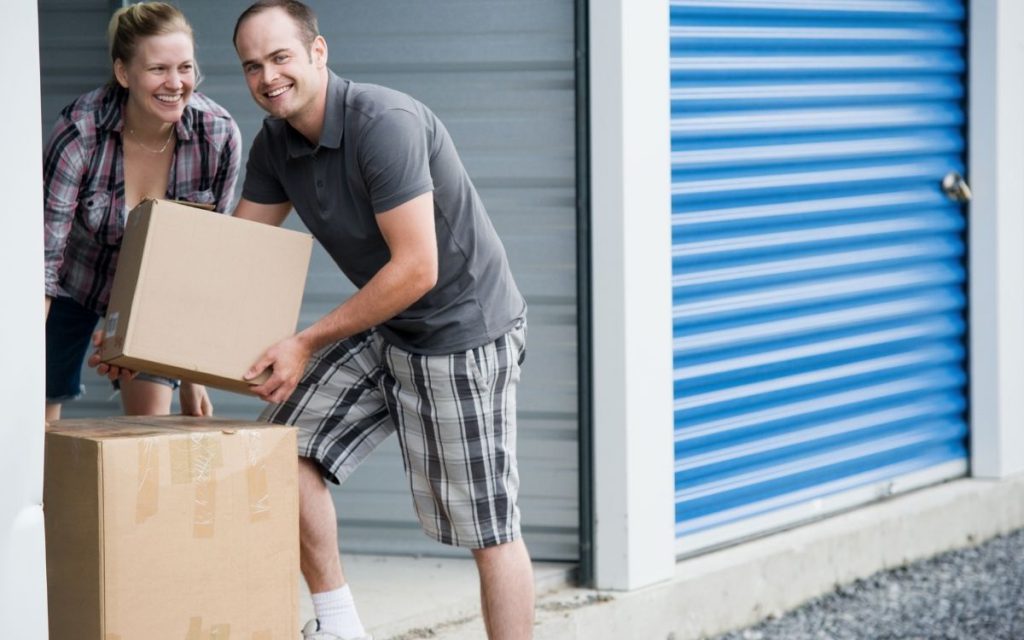 couple moving boxes of belongings into a self-storage unit