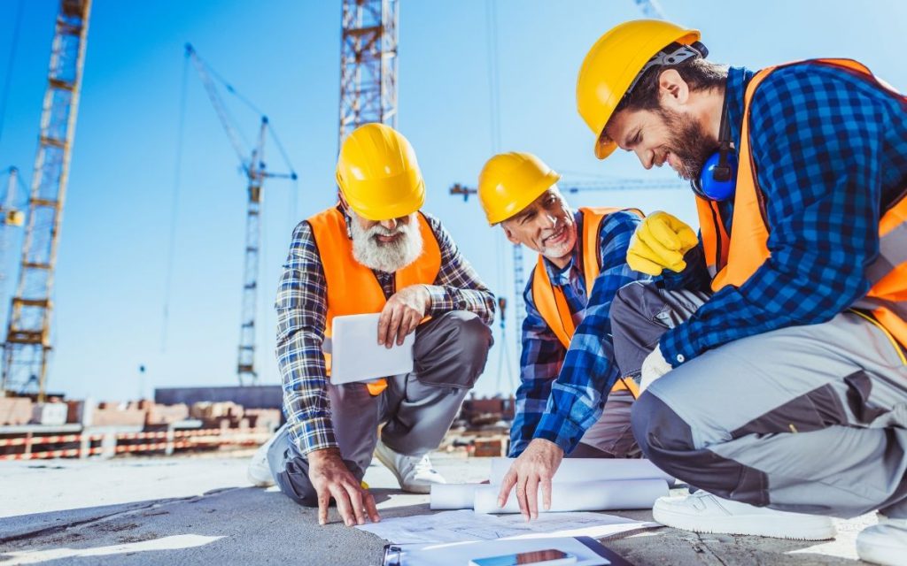 Group of construction workers reviewing plans for a new storage facility