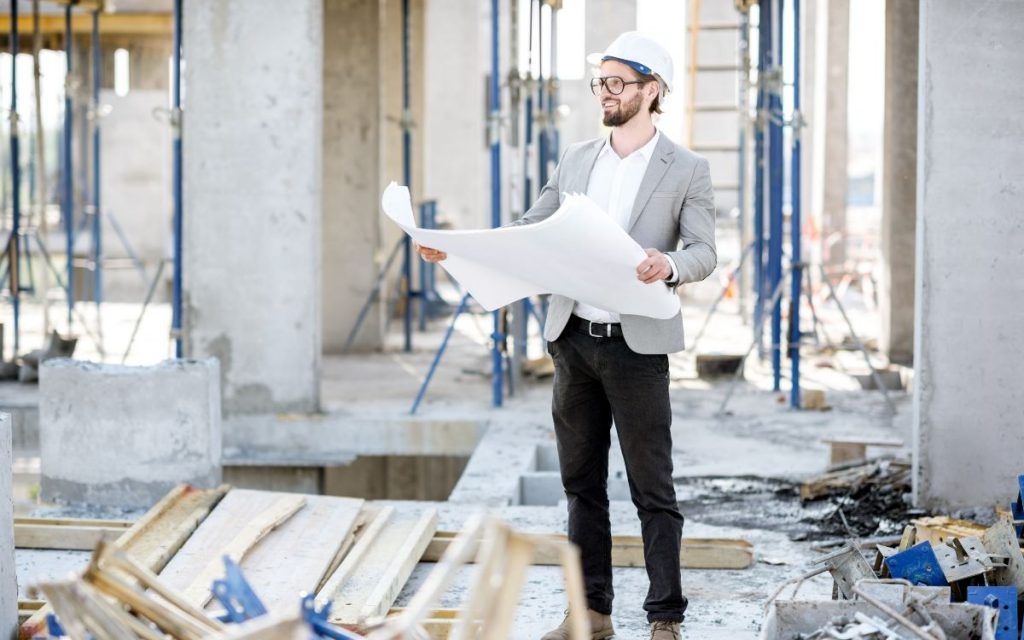 Man looking at plans in a construction site